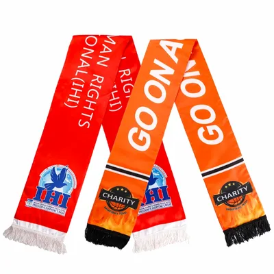 Custom rally towels in red and orange featuring printed text and logos, advertising a charitable cause, displayed against a white background. Custom rally towels in red and orange featuring printed text and logos, advertising a charitable cause, displayed against a white background.