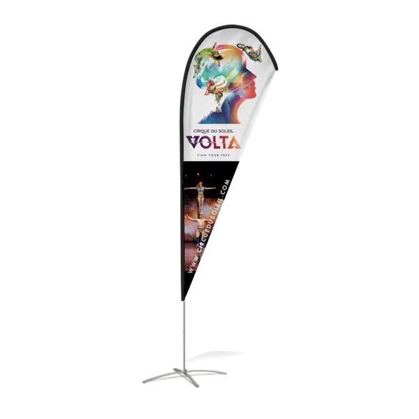 A vertical banner stand presents a vibrant advertisement for 'Cirque du Soleil VOLTA,' featuring stylized acrobatic imagery, set against a nondescript, partially striped background.